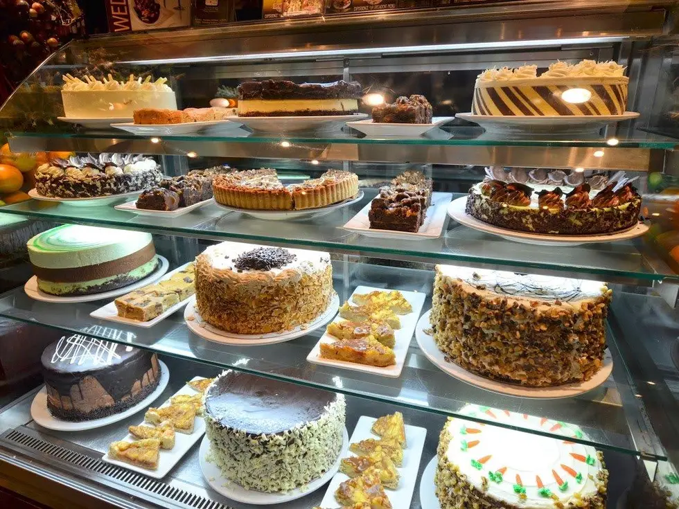  Symposium Cafe Restaurant Milton dessert showcase with decadent cakes leading to our photo gallery featuring breakfast, desserts, drinks, dining room, patio, and food photos
