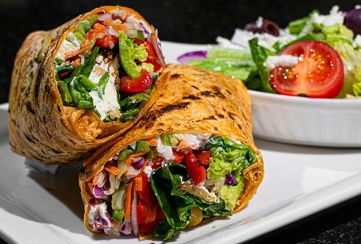 Vegetarian Wrap and Salad at Symposium Cafe Restaurant Thornhill, a family restaurant serving up gourmet comfort food for lunch, dinner and late night dining.