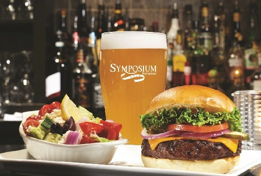 Burger with side salad and Beer Features on Monday at Symposium Waterdown