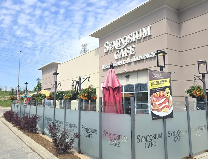 Symposium Cafe Restaurant Waterloo family restaurant exterior facade and outdoor patio seating located on Erb Street, at Westside Marketplace, beside Costco and minutes from The Boardwalk