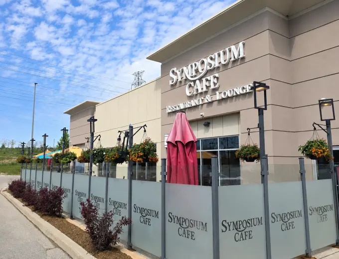 Symposium Cafe Restaurant Waterloo family restaurant exterior facade and outdoor patio seating located on Erb Street, at Westside Marketplace, beside Costco and minutes from The Boardwalk