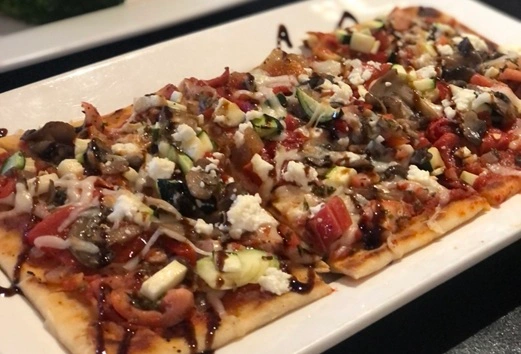 Vegetarian Flatbread appetizer at Symposium Cafe Restaurant Waterloo, a family restaurant serving up gourmet comfort food for lunch, dinner and late night dining.