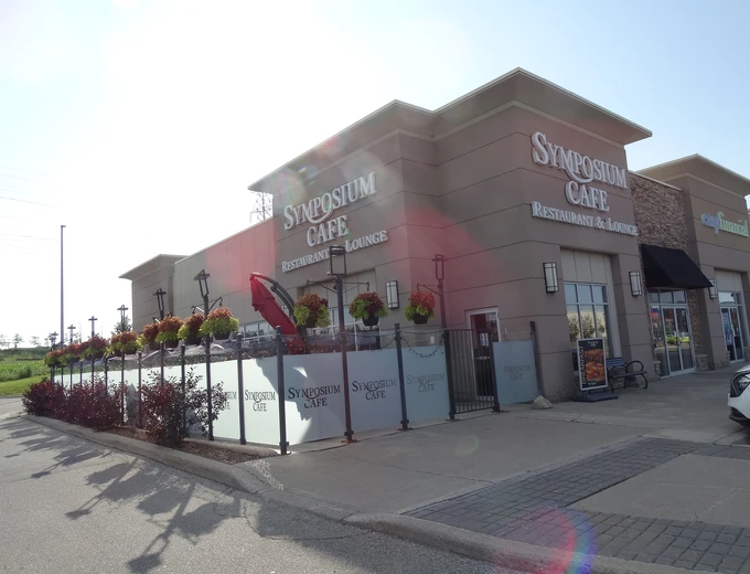 Symposium Cafe Restaurant Waterloo family restaurant exterior facade and outdoor patio seating located on Erb Street, at Westside Marketplace, beside Costco and minutes from The Boardwalk